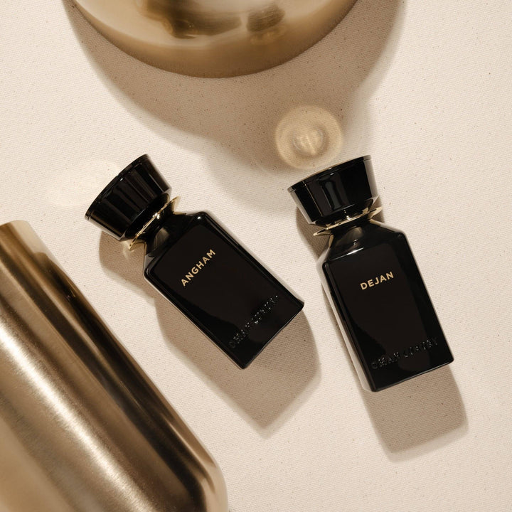 Oman Luxury Angham Eau de Parfum bottle flat lay with brushed brass and Dejan