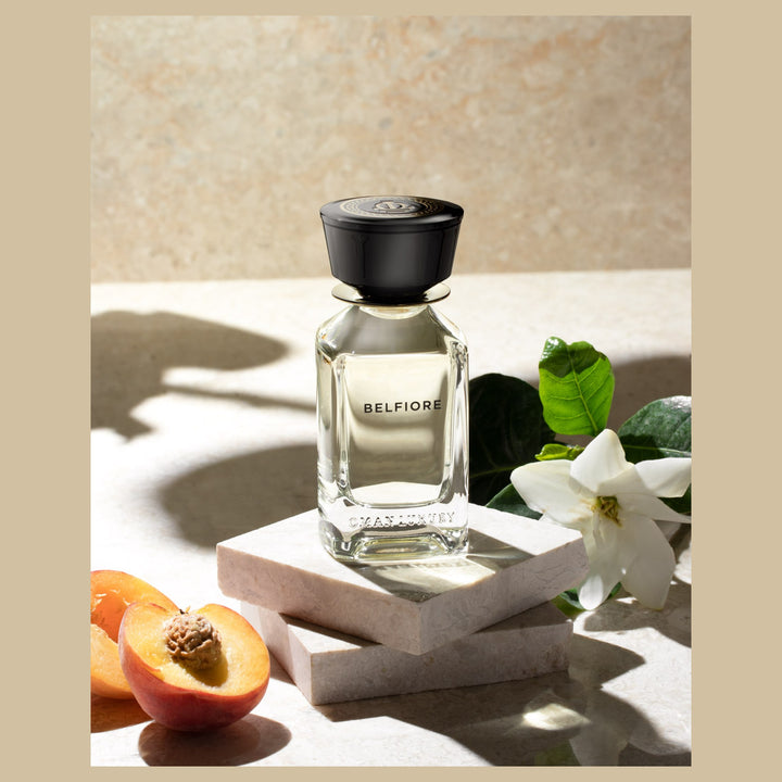 Oman Luxury Belfiore Eau de Parfum bottle on pale stone with jasmine and apricot