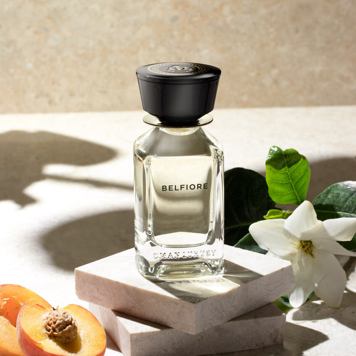 Oman Luxury Belfiore Eau de Parfum bottle on pale stone with jasmine and apricot