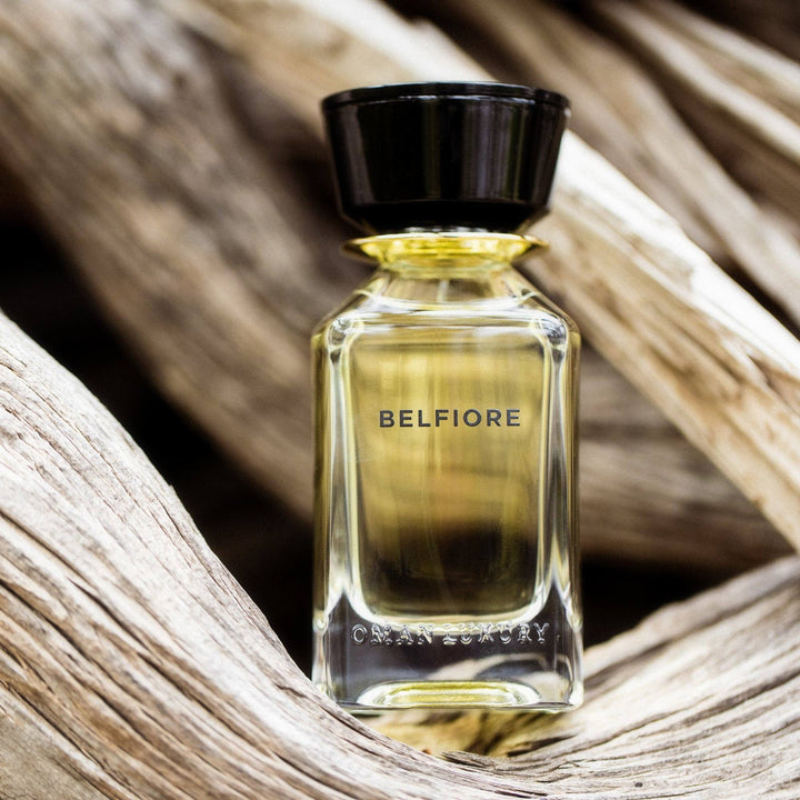 Oman Luxury Belfiore Eau de Parfum bottle cradled in sun-bleached weathered wood