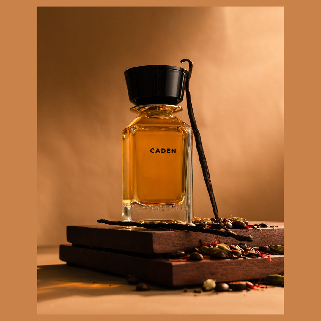 Oman Luxury Caden Eau de Parfum bottle on dark wood with coffee beans