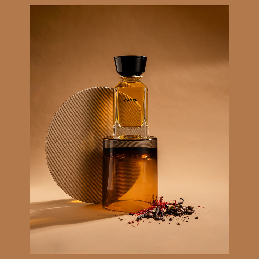Oman Luxury Caden Eau de Parfum bottle against a stone disc with scattered spice