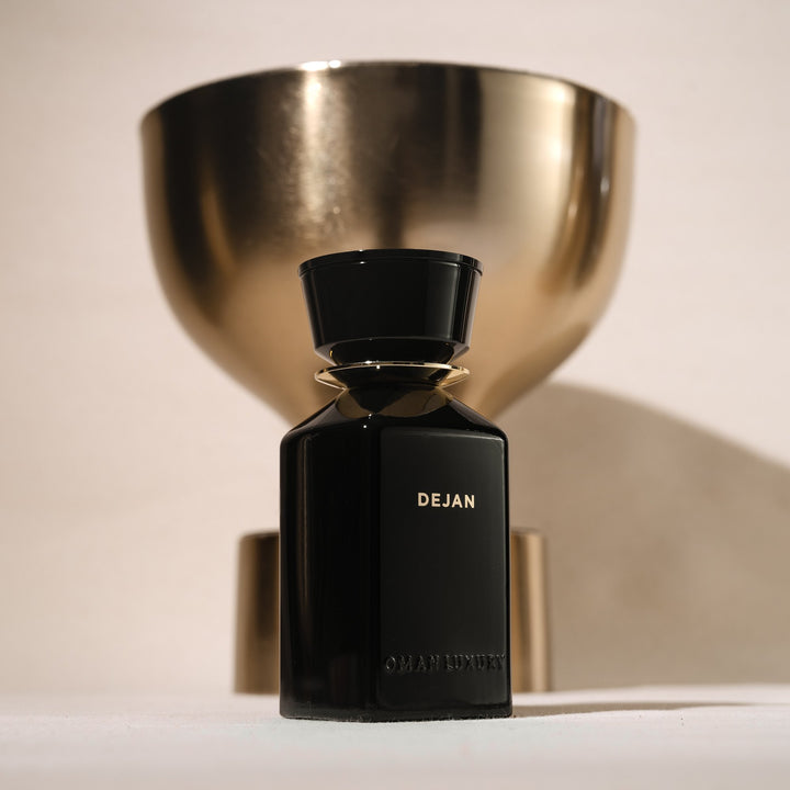 Oman Luxury Dejan Eau de Parfum bottle beneath a polished brass bowl