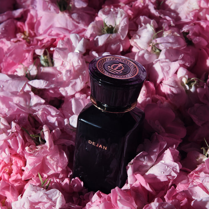 Oman Luxury Dejan Eau de Parfum bottle buried in fresh damask rose petals