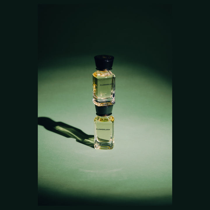 Oman Luxury Flowerlush Eau de Parfum bottle against a deep green studio backdrop