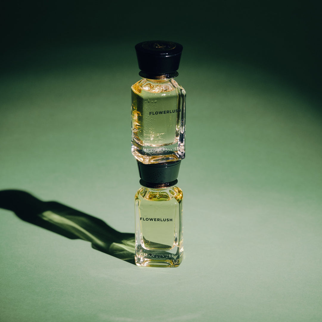 Oman Luxury Flowerlush Eau de Parfum bottle against a deep green studio backdrop