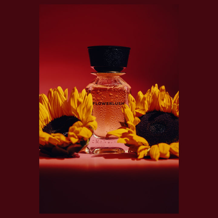 Oman Luxury Flowerlush Eau de Parfum bottle with sunflowers on red