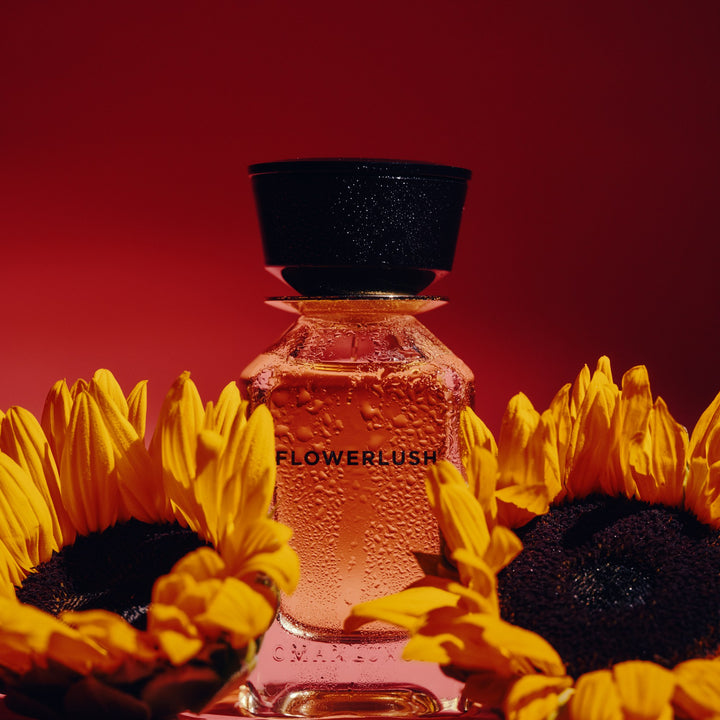 Oman Luxury Flowerlush Eau de Parfum bottle with sunflowers on red