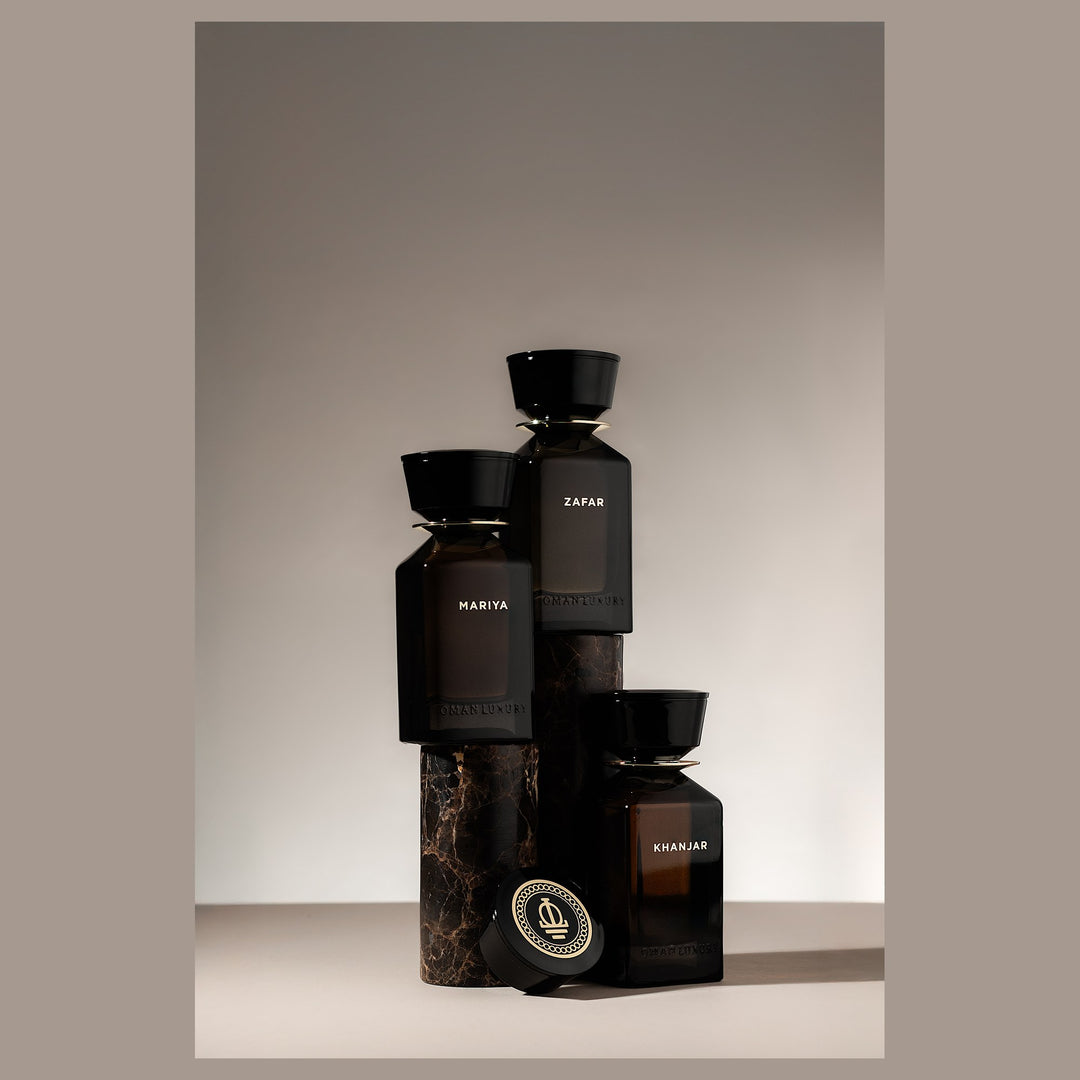 Oman Luxury Khanjar Eau de Parfum bottle stacked with the house bottles on stone