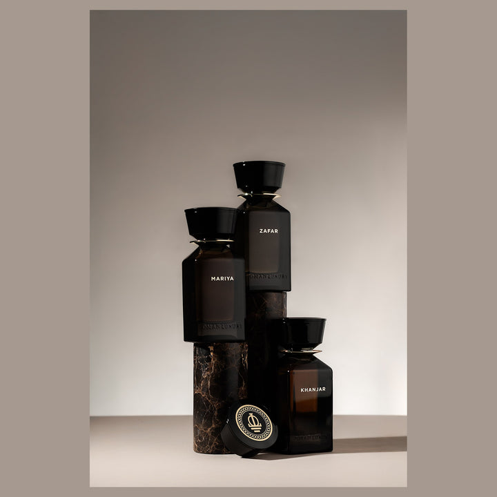Oman Luxury Khanjar Eau de Parfum bottle stacked with the house bottles on stone
