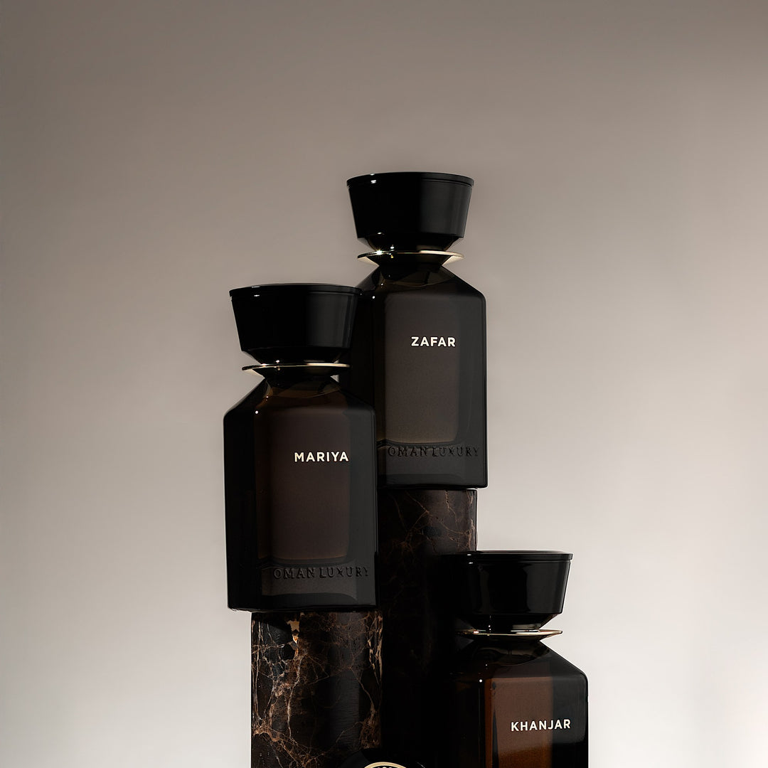 Oman Luxury Khanjar Eau de Parfum bottle stacked with the house bottles on stone