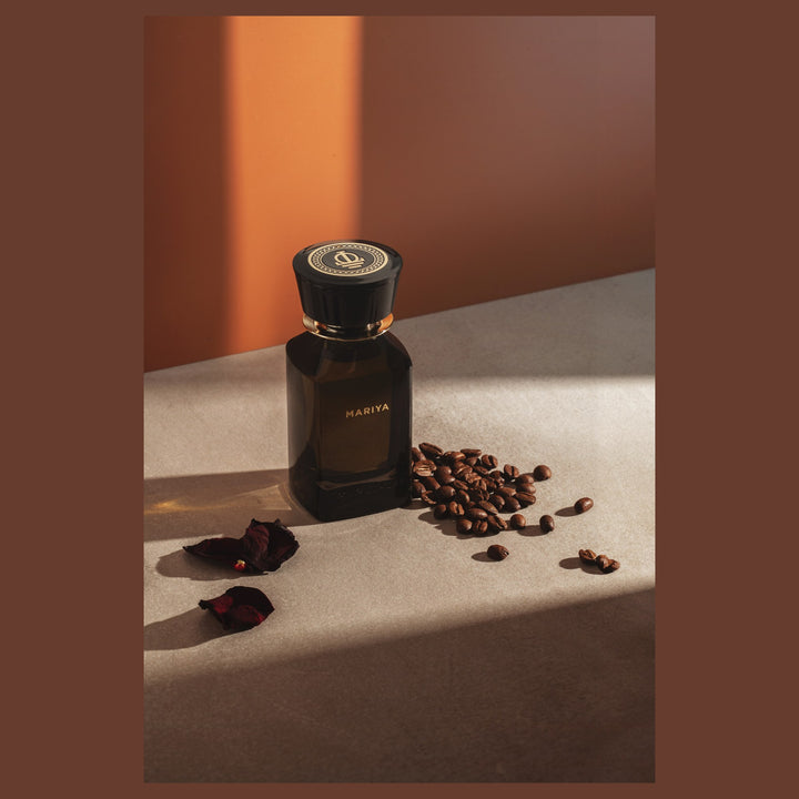 Oman Luxury Mariya Eau de Parfum bottle on a stone ledge with coffee beans