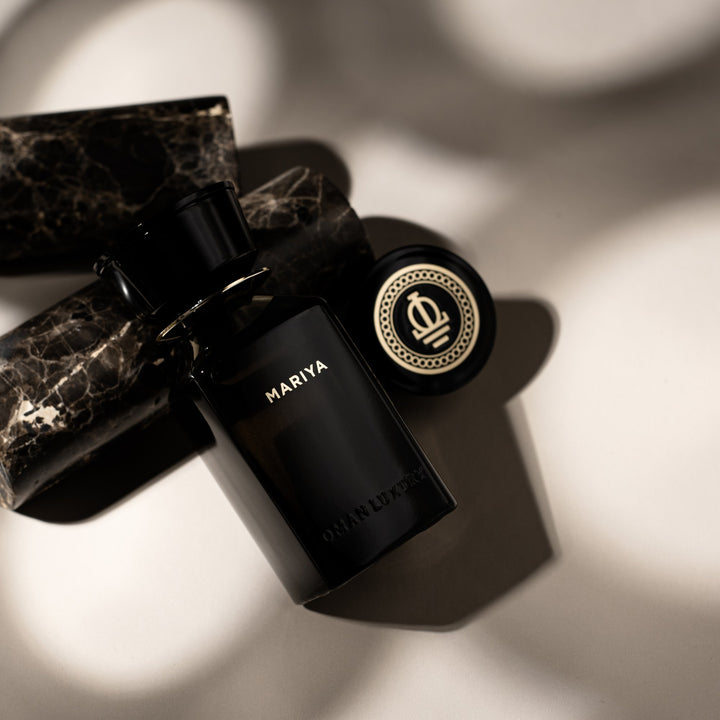 Oman Luxury Mariya Eau de Parfum bottle on black marble with its crested cap