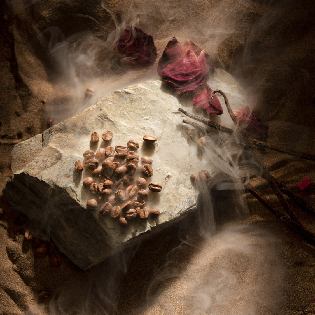 Oman Luxury Mariya Eau de Parfum bottle with rose petals and coffee in soft haze
