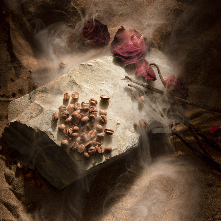 Oman Luxury Mariya Eau de Parfum bottle with rose petals and coffee in soft haze