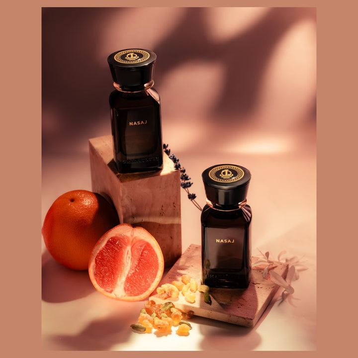 Oman Luxury Nasaj Eau de Parfum bottle with halved grapefruit and dried flowers