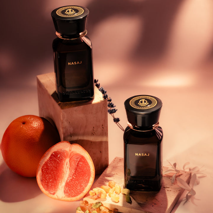 Oman Luxury Nasaj Eau de Parfum bottle with halved grapefruit and dried flowers