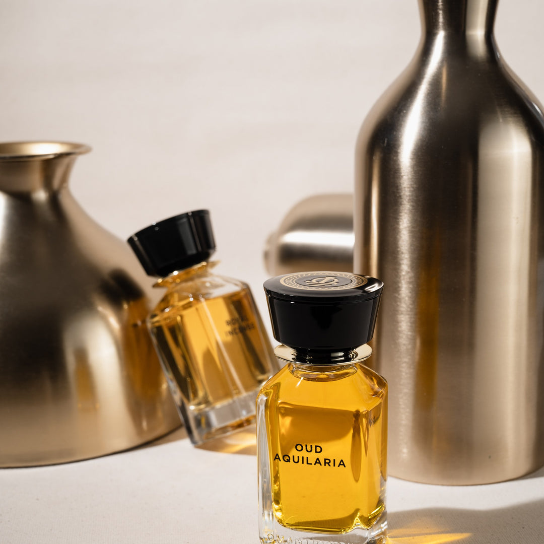 Oman Luxury Oud Aquilaria Eau de Parfum bottle beside brushed brass vessels