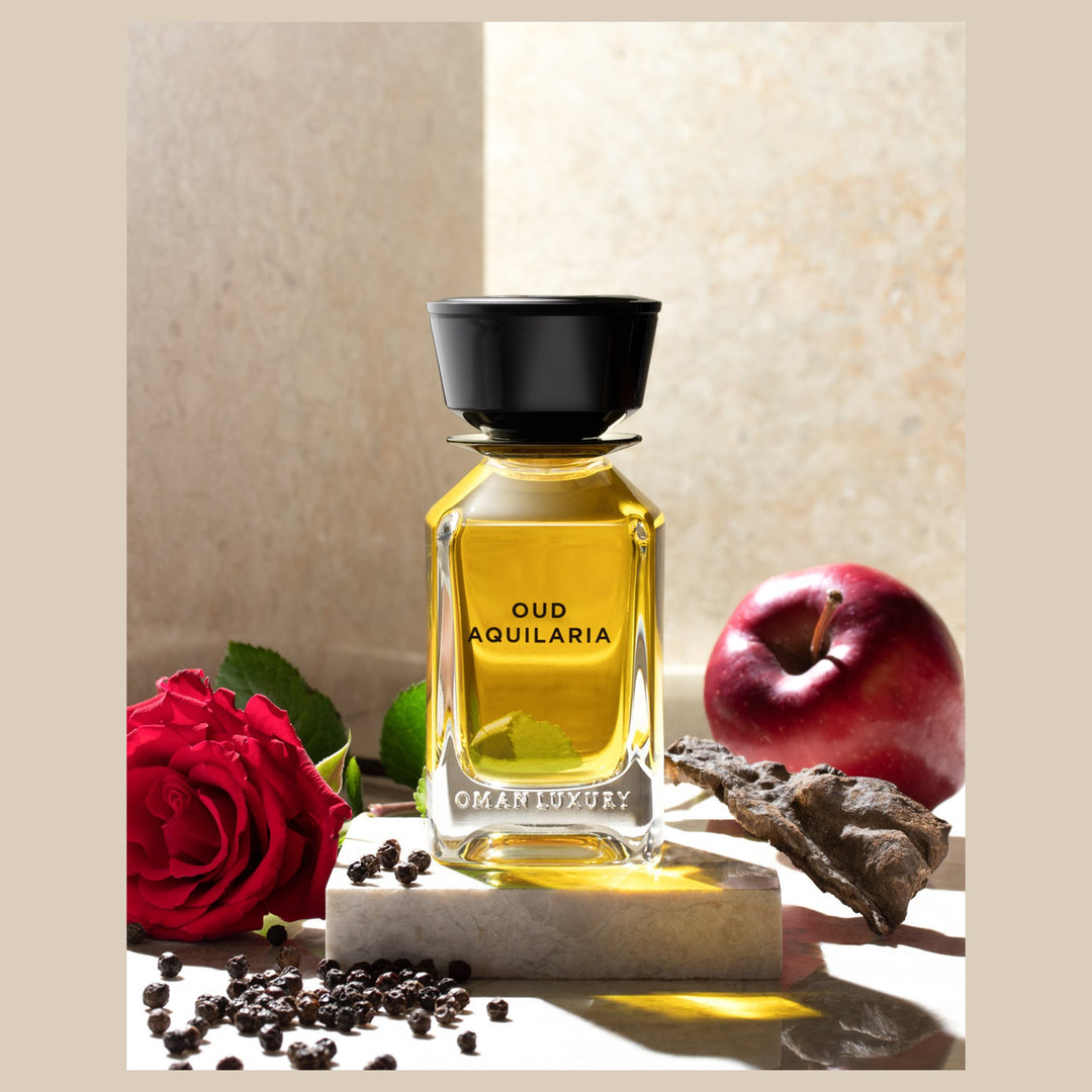 Oman Luxury Oud Aquilaria Eau de Parfum bottle with red roses and pomegranate