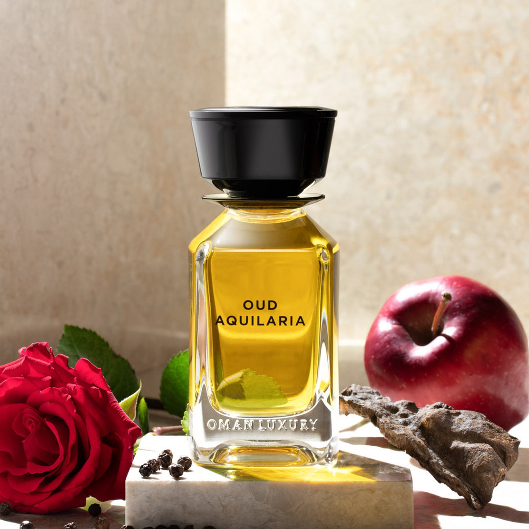 Oman Luxury Oud Aquilaria Eau de Parfum bottle with red roses and pomegranate