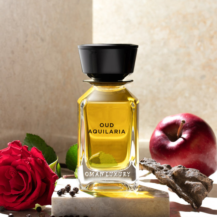 Oman Luxury Oud Aquilaria Eau de Parfum bottle with red roses and pomegranate