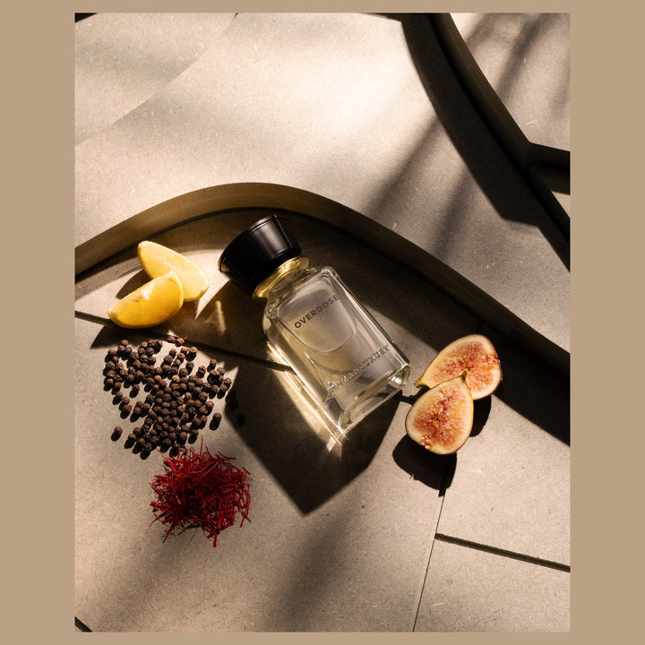 Oman Luxury Overdose Eau de Parfum bottle flat lay with fig, saffron and peppercorns
