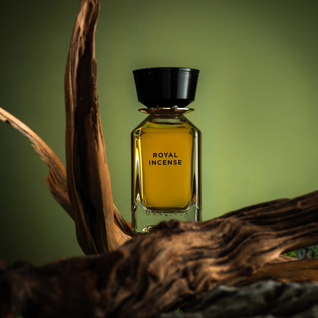 Oman Luxury Royal Incense Eau de Parfum bottle on driftwood against green studio light