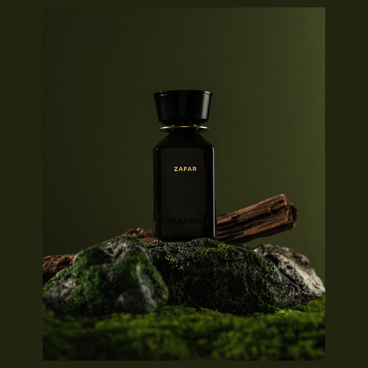 Oman Luxury Zafar Eau de Parfum bottle on moss and rock against green